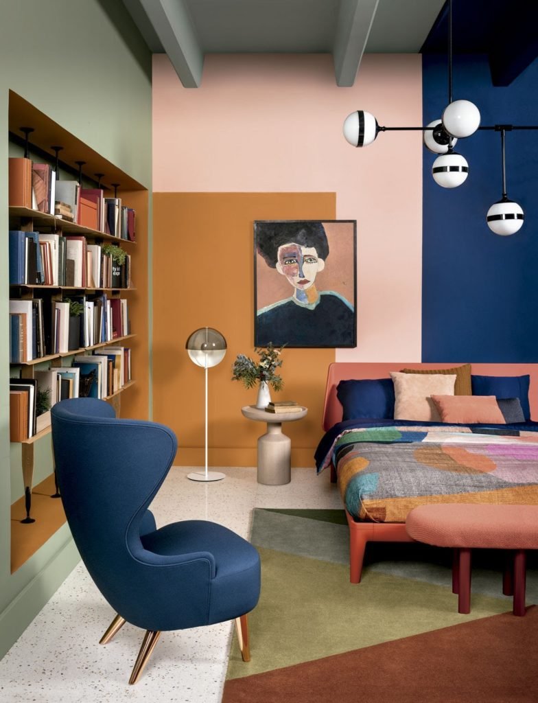 room with orange, green, blush and classic blue wall and mid century modern furniture