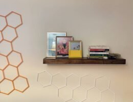 good clutter - floating shelves with books and picture frames