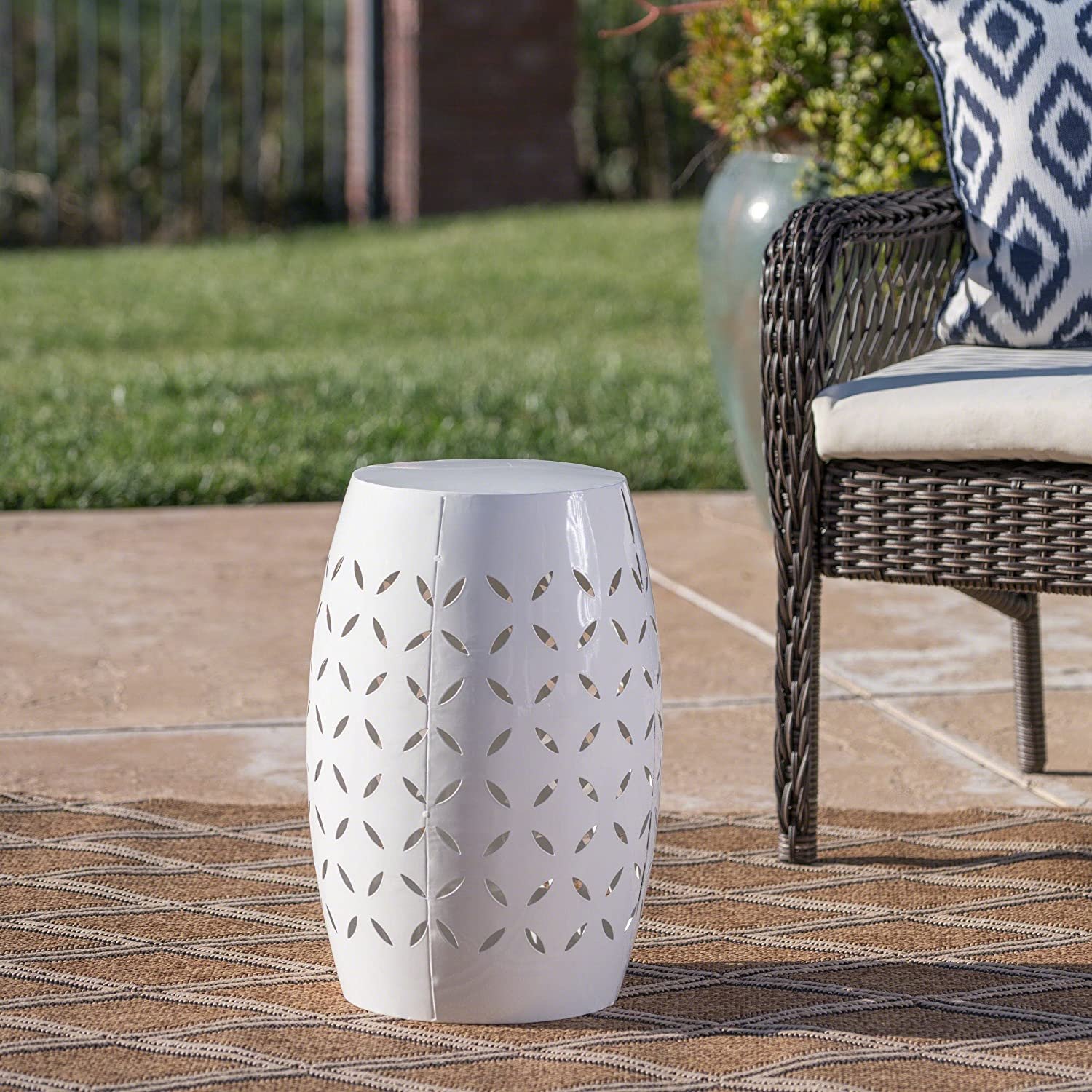 White tin cylindrical side table with patterned cutouts
