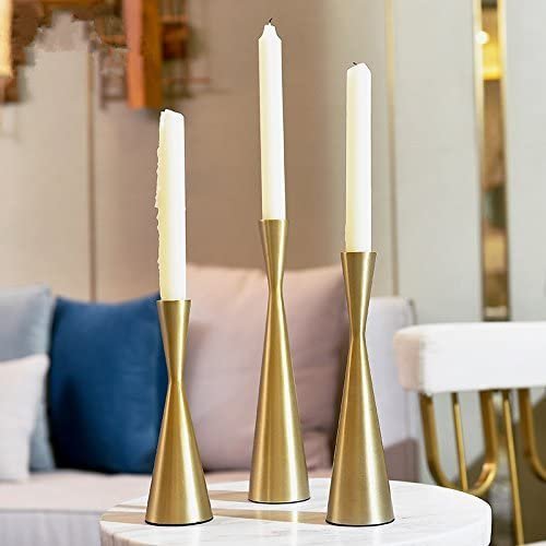 set of 3 brass candlesticks with a subtle hourglass shape