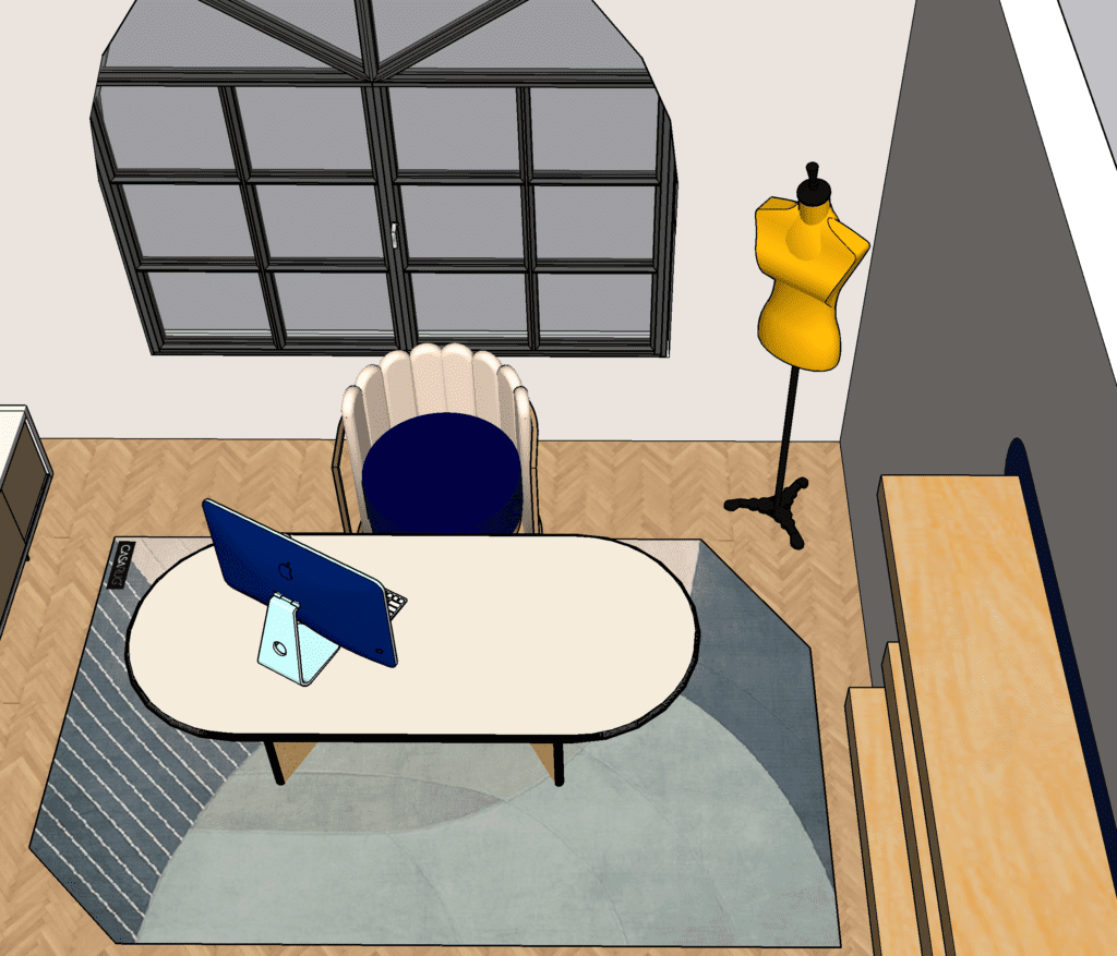 office with an oval desk atop a geometric blue toned rug. a blue m1 iMac sitting on the desk. yellow clothing rack in the corner. Large arched window at the back of the room. 