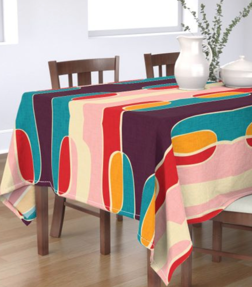 Colorful mid century modern style tablecoth on a dark walnut dining table - thanksgiving accent pieces