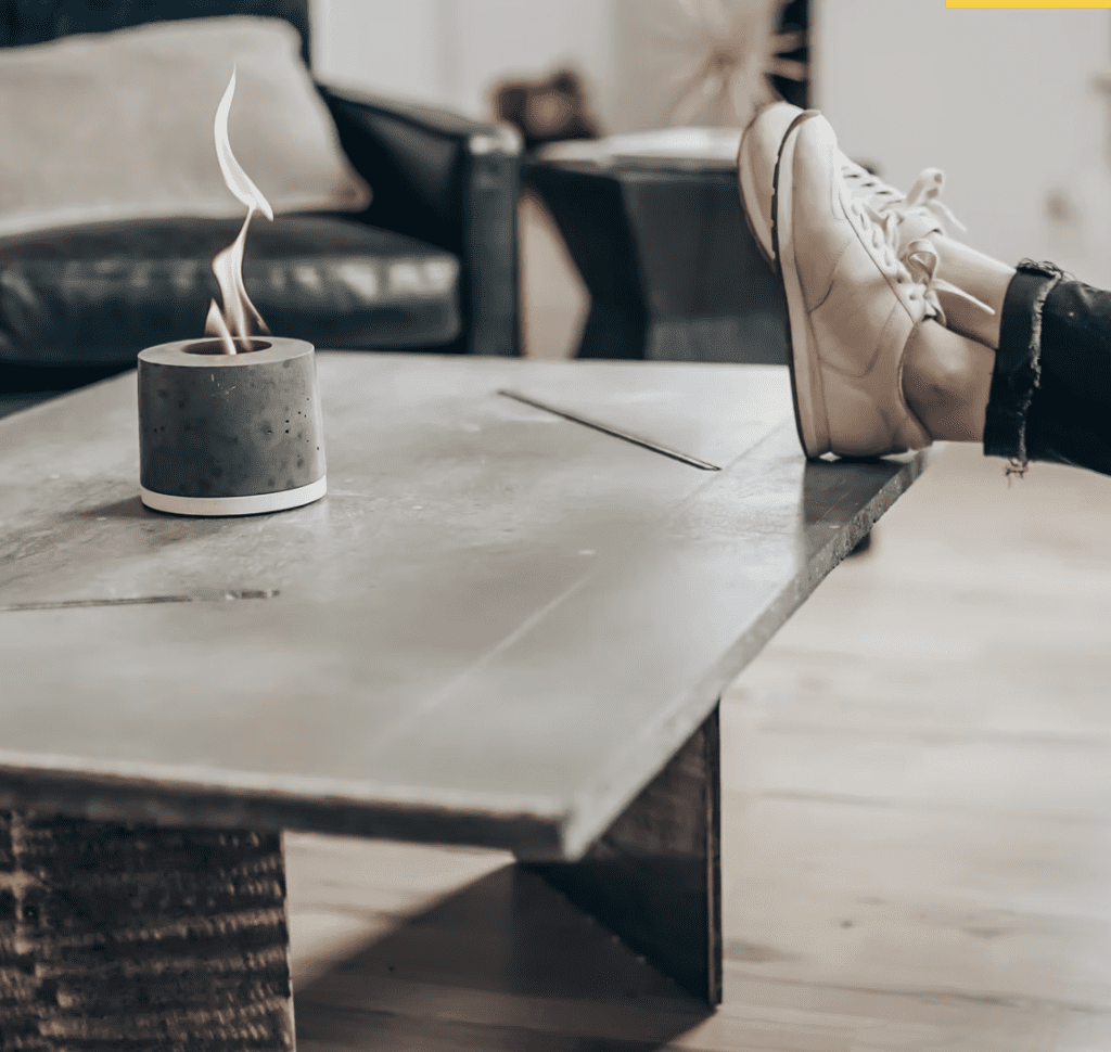 mini personal concrete fireplace on a coffee table