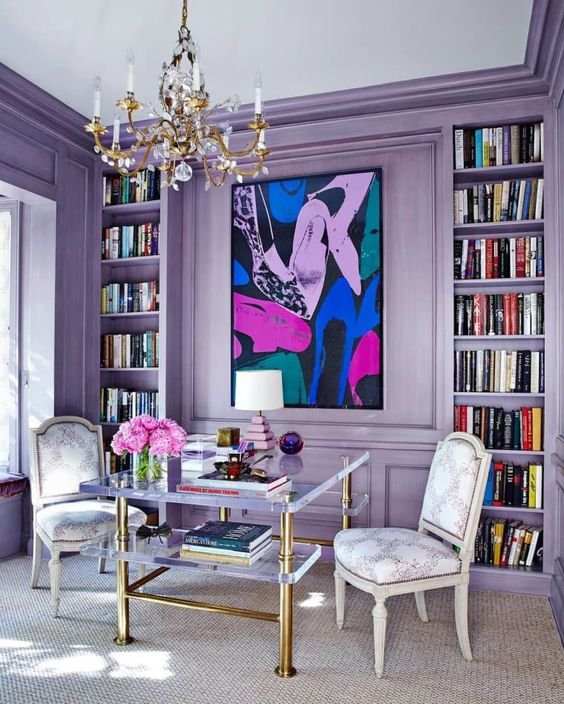 Office/library with purple walls and bookshelves
