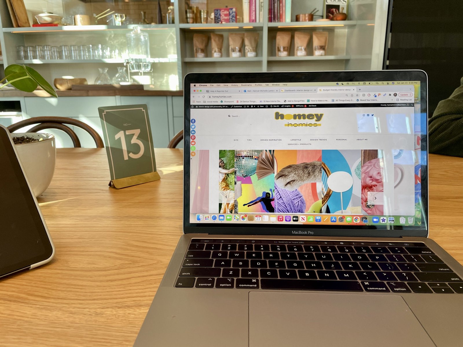 laptop sitting on a table of a hip and stylish coffee shop - the best interior design blogs