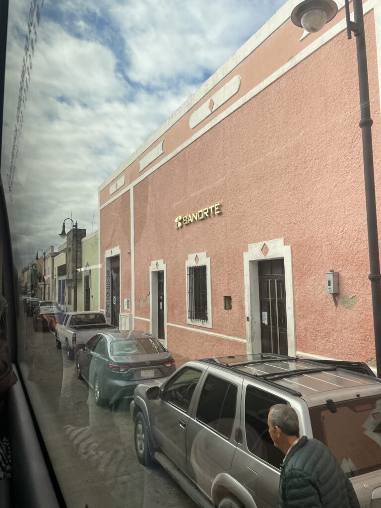 The exteriors of several shops on the streets of a colonial Spanish town outside of Cancun