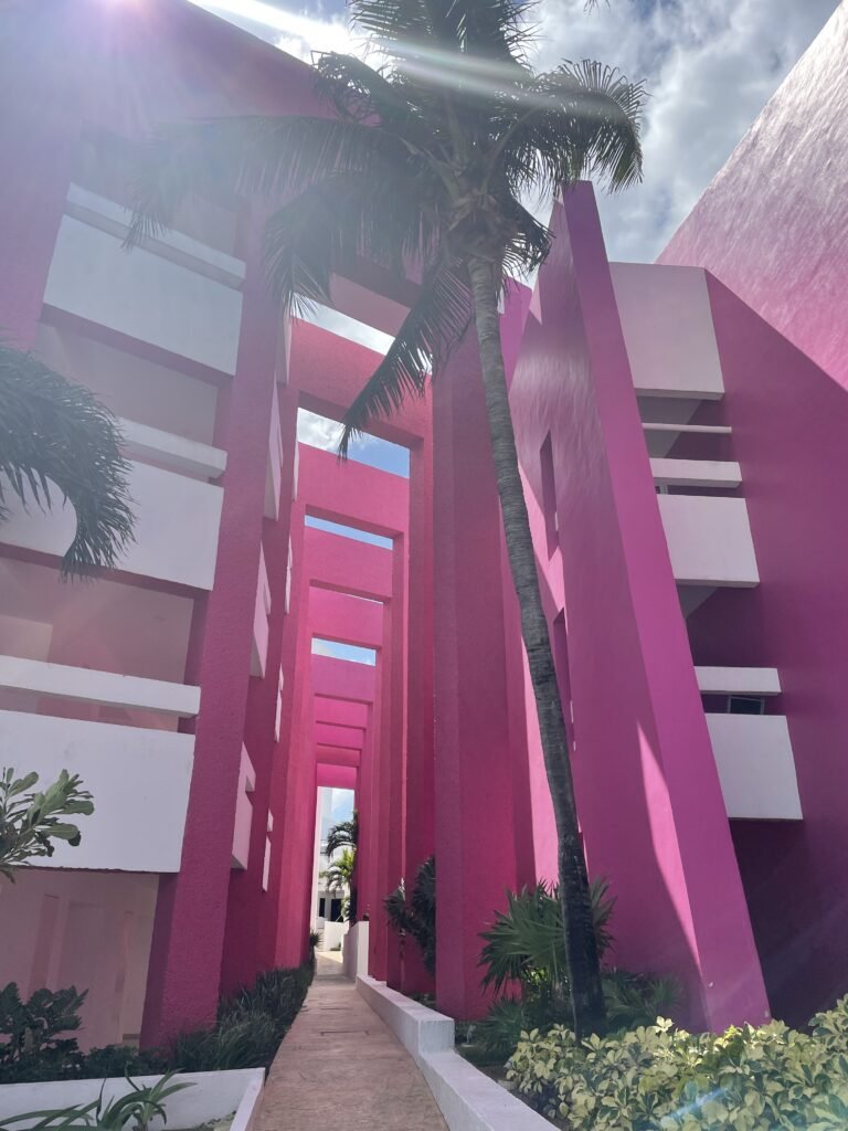 Bright pink exterior of a Cancun luxury resort