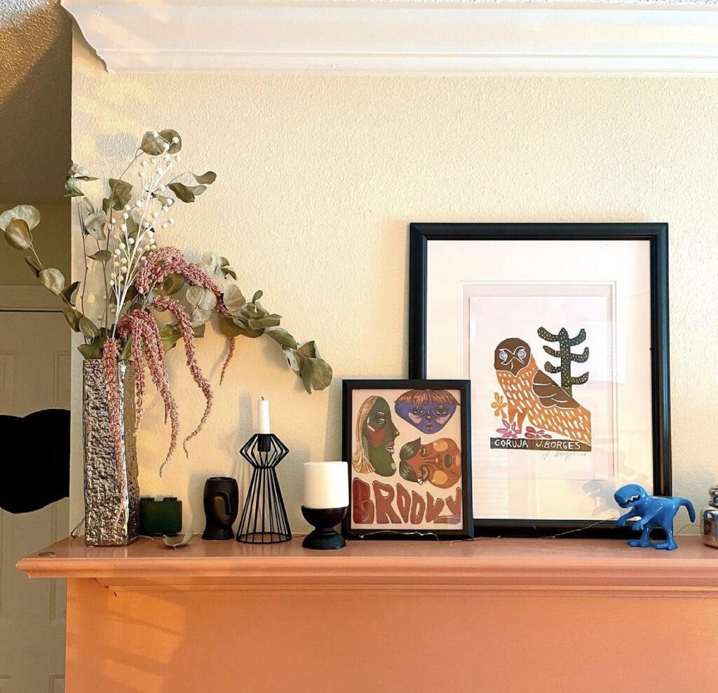 peach colored mantel with funky decorations on top