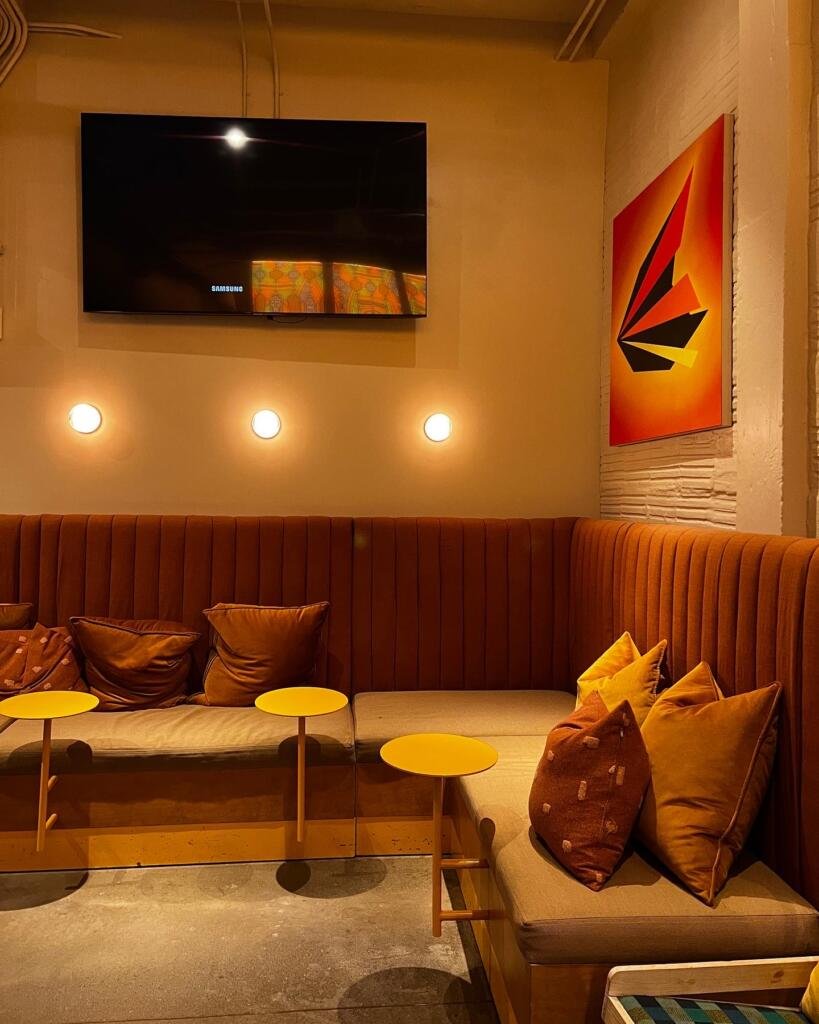 Corner seating at the Saint Julep bar with a rust orange velvet couch
