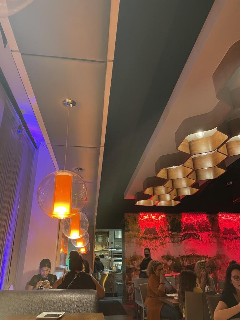 THRIVE downtown restaurant with funky globe pendant lights and honeycomb details and neon light accents