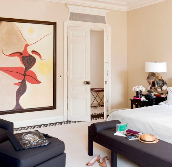 A luxurious bedroom with oversized artwork of two figures kissing