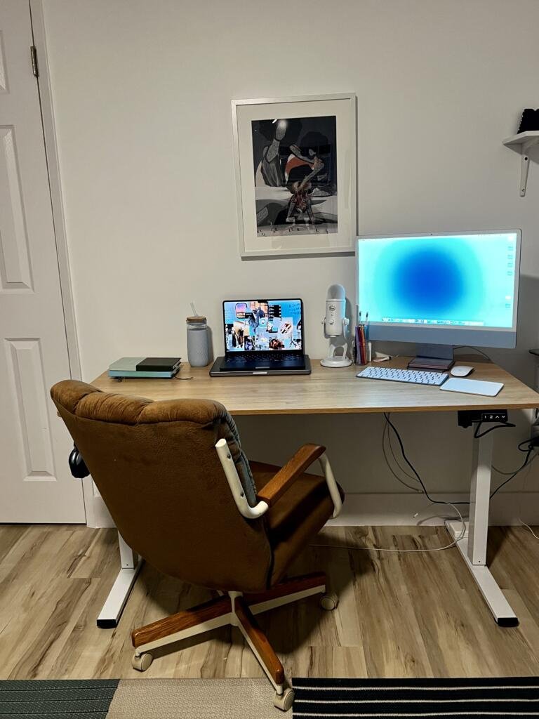 workspace setup with a comfy ergonomic sueded chair and an adjustable sit stand desk