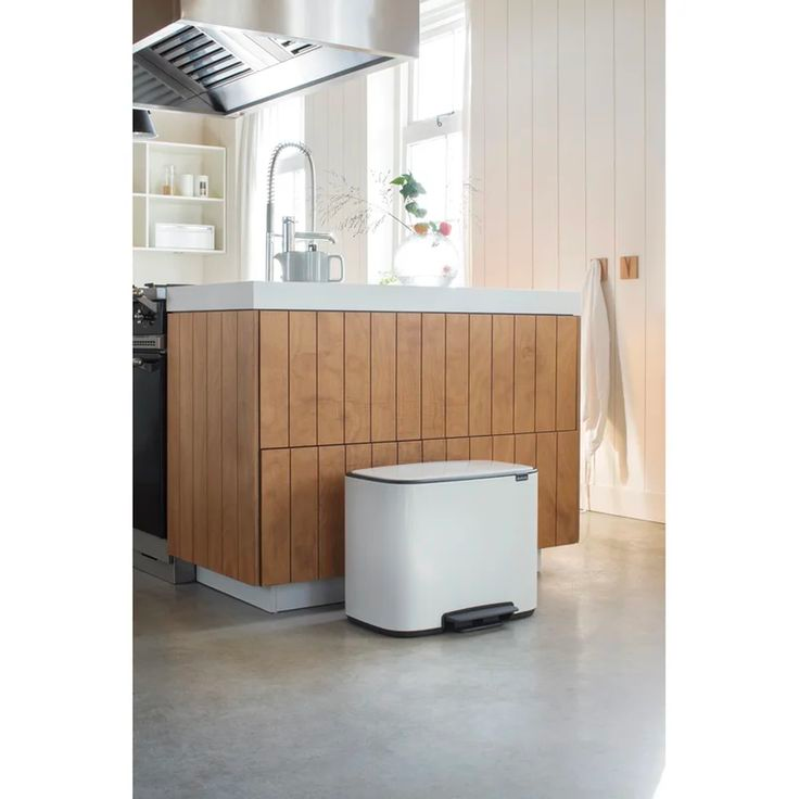 Modern and luxurious trash can sitting in a kitchen